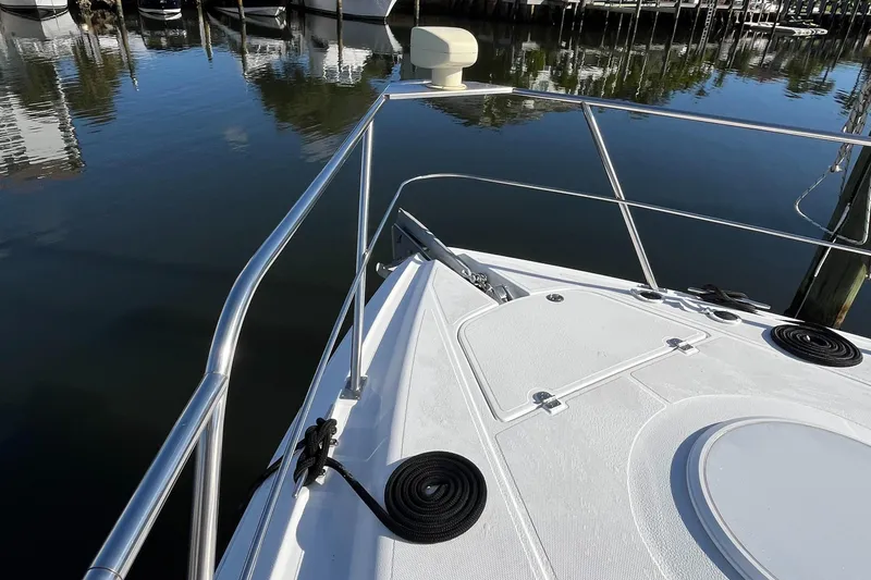 Slide: The Image of Bow of 2000 Cruisers Yachts 4450 Motor Yacht docked in calm marina waters. - 25