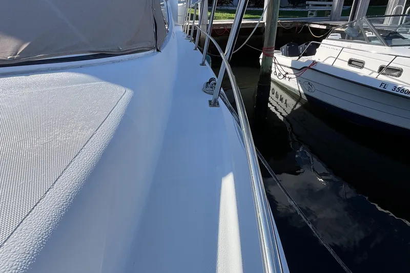 Slide: The Image of 2000 Cruisers Yachts 4450 Motor Yacht docked beside another boat. - 29