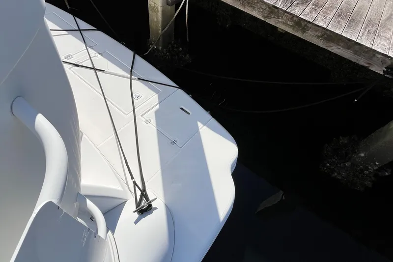 Slide: The Image of 2000 Cruisers Yachts 4450 Motor Yacht docked, showing deck and mooring lines. - 43