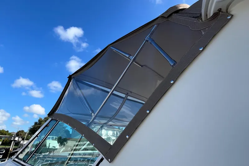 Slide: The Image of 2000 Cruisers Yachts 4450 Motor Yacht with clear canopy under blue sky. - 47