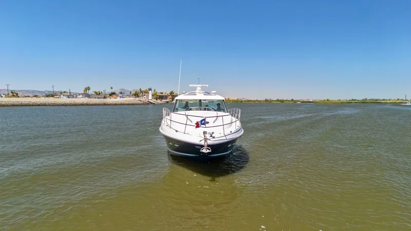 Slide: The Image of 2009 Sea Ray 43 Sundancer yacht cruising on a sunny day in calm waters. - 14