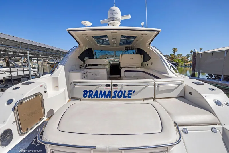 Slide: The Image of 2009 Sea Ray 43 Sundancer yacht, rear view, docked under clear blue sky. - 21
