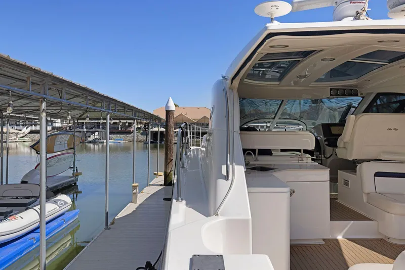 Slide: The Image of 2009 Sea Ray 43 Sundancer yacht docked at marina under clear blue sky. - 25