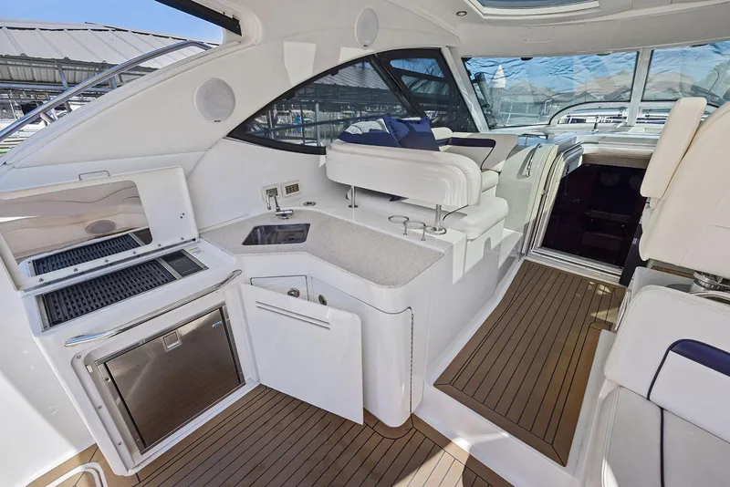 Slide: The Image of 2009 Sea Ray 43 Sundancer yacht interior with kitchenette and seating area. - 28