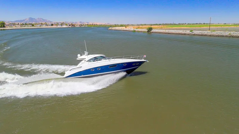 Slide: The Image of 2009 Sea Ray 43 Sundancer yacht cruising on a sunny day in a scenic waterway. - 3