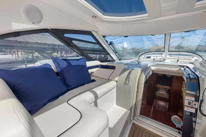 Slide: The Image of Luxurious interior of 2009 Sea Ray 43 Sundancer yacht with blue cushions and panoramic windows. - 32