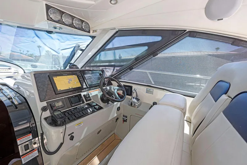 Slide: The Image of 2009 Sea Ray 43 Sundancer helm with navigation system and luxurious seating. - 33