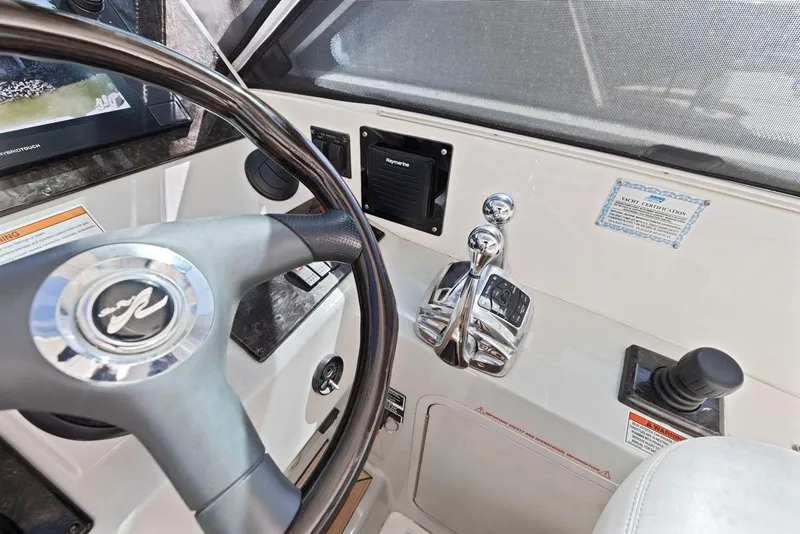 Slide: The Image of 2009 Sea Ray 43 Sundancer helm with steering wheel and control panel. - 35