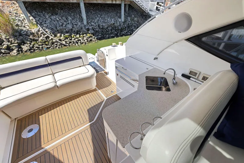 Slide: The Image of 2009 Sea Ray 43 Sundancer yacht interior with seating, sink, and wooden deck. - 37