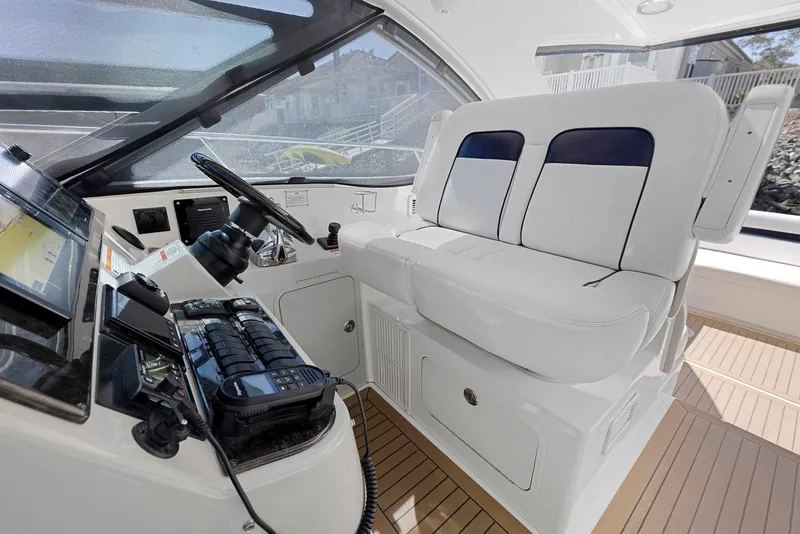 Slide: The Image of 2009 Sea Ray 43 Sundancer helm with dual seats and modern controls. - 39