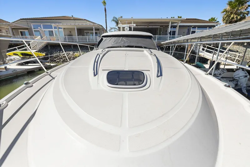 Slide: The Image of 2009 Sea Ray 43 Sundancer yacht docked at marina, showcasing sleek deck design. - 43