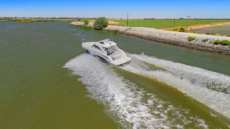 Slide: The Image of 2009 Sea Ray 43 Sundancer cruising on a scenic waterway. - 5