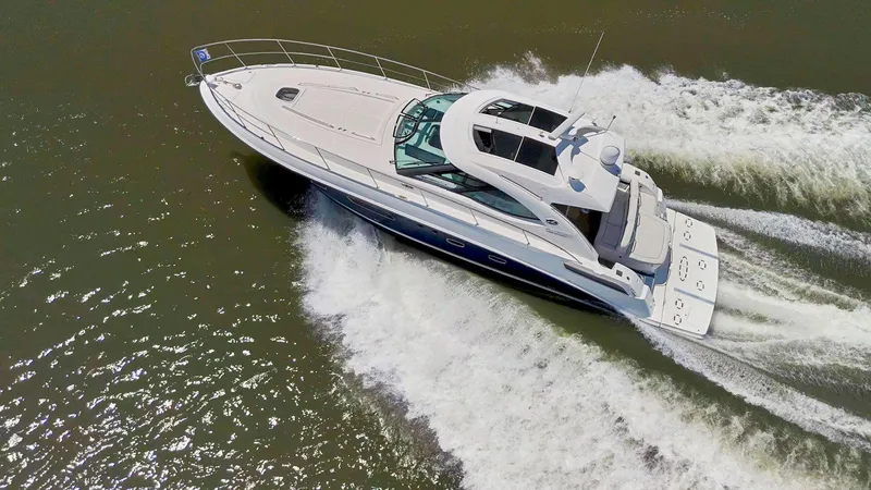 Slide: The Image of 2009 Sea Ray 43 Sundancer yacht cruising on open water, aerial view. - 9