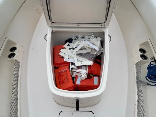 Slide: The Image of Open storage compartment on 2012 Grady-White 271 Canyon boat with safety equipment. - 12