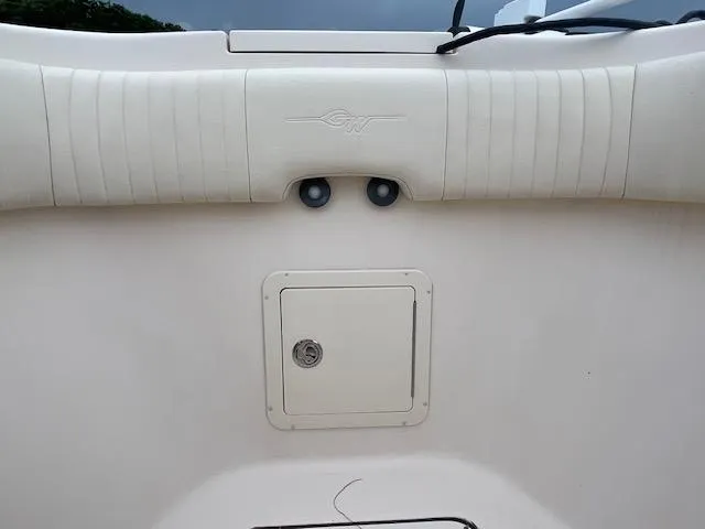 Slide: The Image of 2012 Grady-White 271 Canyon boat interior with storage compartment and padded seating. - 19