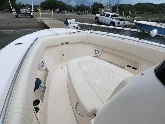 Slide: The Image of 2012 Grady-White 271 Canyon boat interior with cushioned seating at a dock. - 20