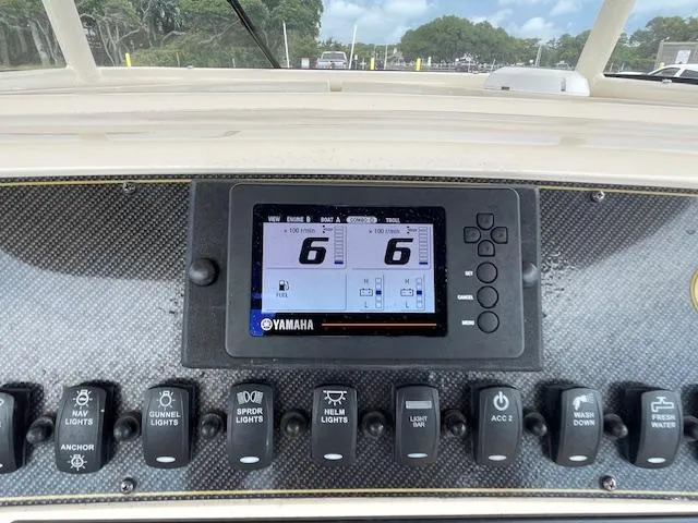 Slide: The Image of Control panel of a 2012 Grady-White 271 Canyon boat with Yamaha display and switches. - 24