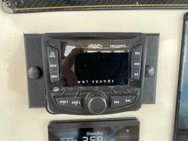 Slide: The Image of Control panel of a 2012 Grady-White 271 Canyon boat featuring a Wet Sounds audio system. - 27