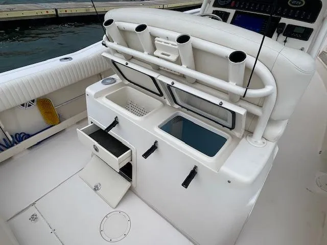 Slide: The Image of 2012 Grady-White 271 Canyon boat interior with storage compartments and rod holders. - 33
