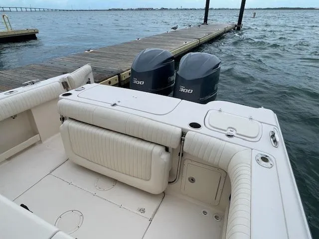 Slide: The Image of 2012 Grady-White 271 Canyon boat with twin 300 engines docked by the water. - 36