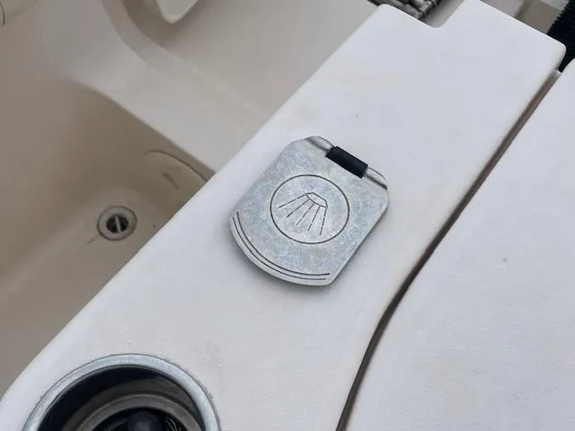 Slide: The Image of 2012 Grady-White 271 Canyon boat detail, featuring a metal latch and cup holder. - 37