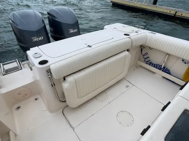 Slide: The Image of 2012 Grady-White 271 Canyon boat with twin 300 horsepower engines, docked by the water. - 42