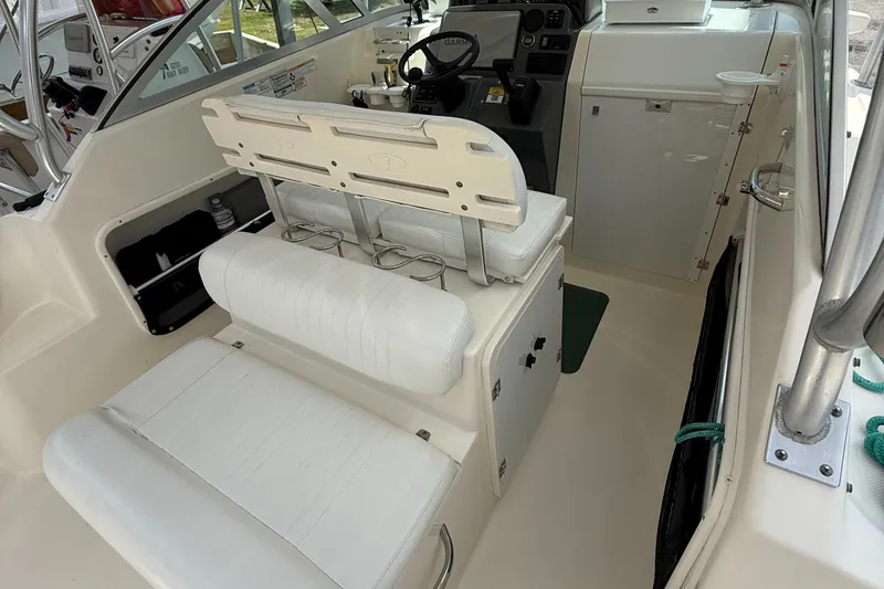 Slide: The Image of 2007 Pursuit 235 Denali LS boat interior with white seating and steering console. - 17