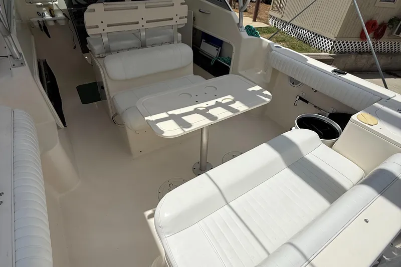 Slide: The Image of 2007 Pursuit 235 Denali LS boat interior with white seating and table. - 19