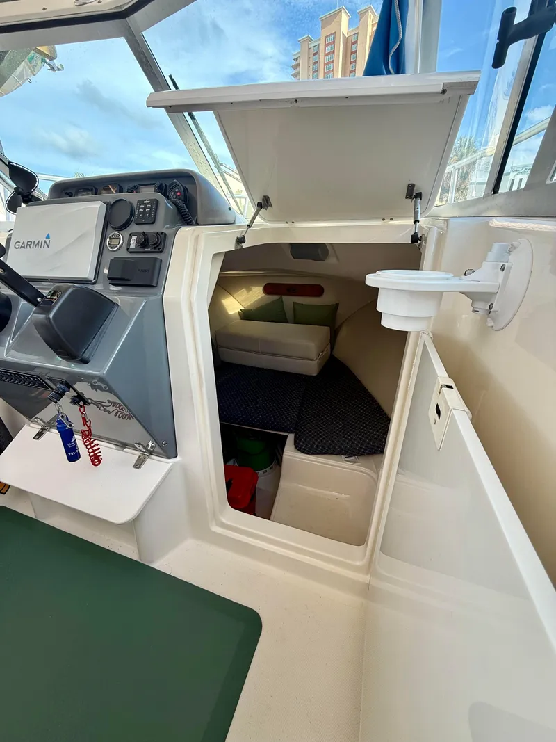 Slide: The Image of 2007 Pursuit 235 Denali LS boat interior with cabin and control panel. - 21