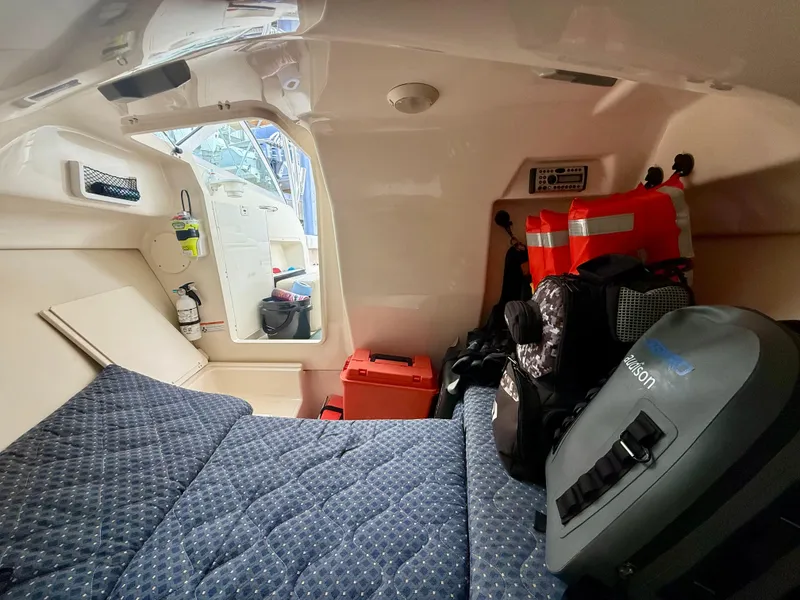 Slide: The Image of Interior cabin of a 2007 Pursuit 235 Denali LS boat with storage and safety gear. - 23