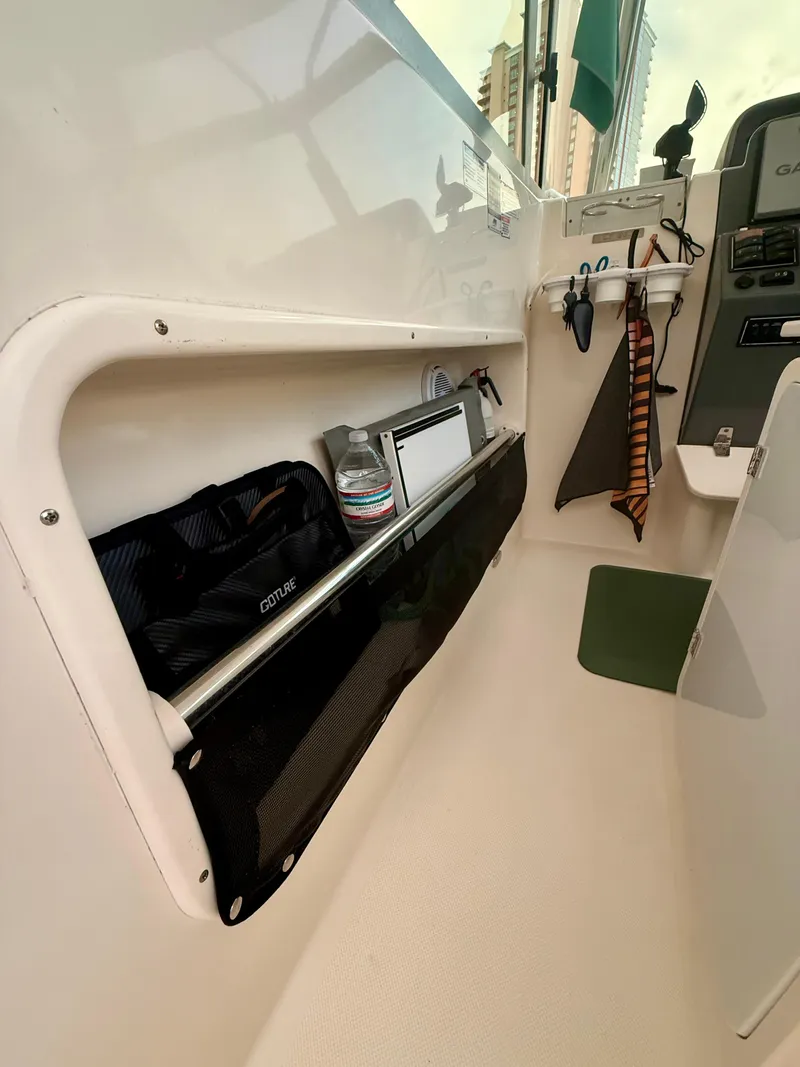 Slide: The Image of Interior storage of 2007 Pursuit 235 Denali LS boat with organized compartments and accessories. - 26