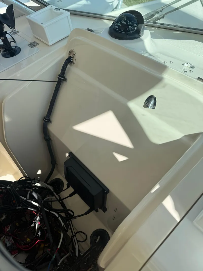 Slide: The Image of 2007 Pursuit 235 Denali LS boat dashboard with compass and wiring. - 29