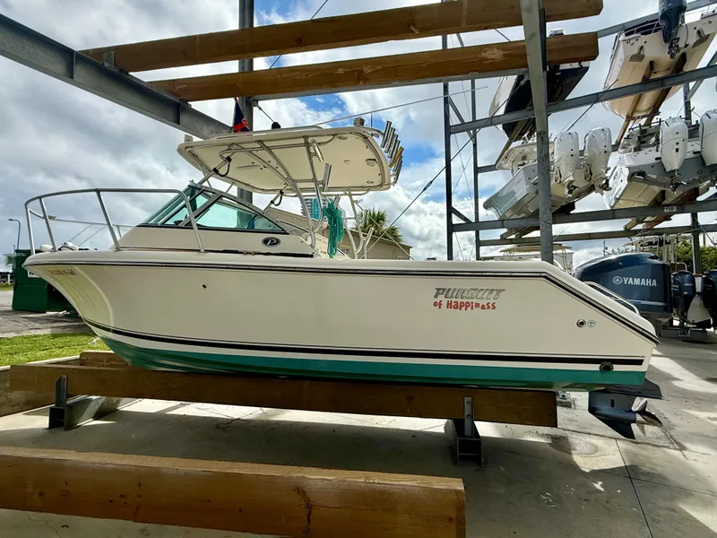 Slide: The Image of 2007 Pursuit 235 Denali LS boat on a lift, with "Pursuit of Happiness" text. - 3