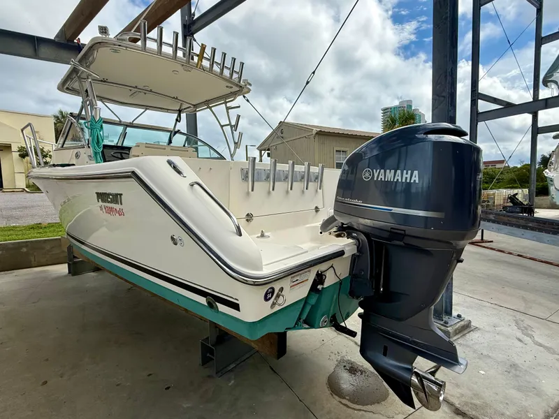 Slide: The Image of 2007 Pursuit 235 Denali LS boat with Yamaha outboard motor in a marina setting. - 5