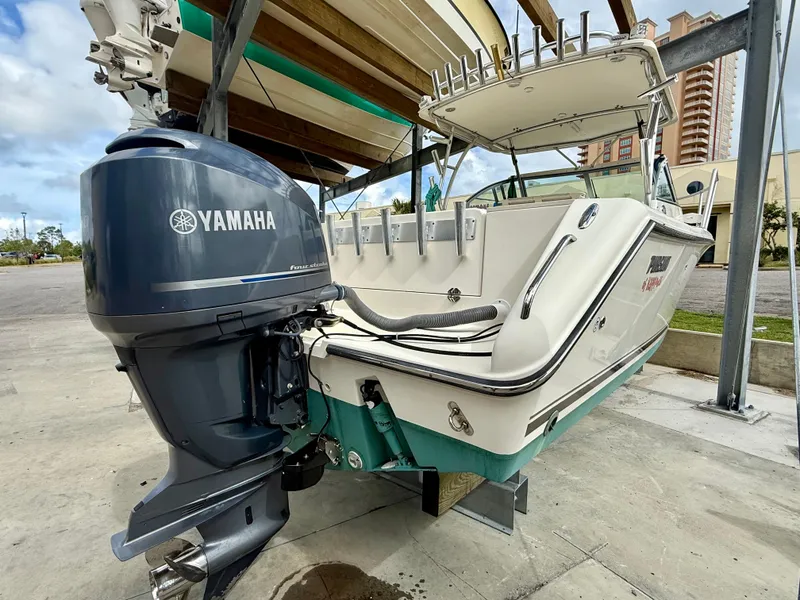Slide: The Image of 2007 Pursuit 235 Denali LS boat with Yamaha outboard motor on a lift. - 6