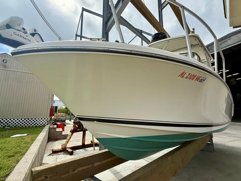 Slide: The Image of 2007 Pursuit 235 Denali LS boat on a wooden stand, side view. - 7