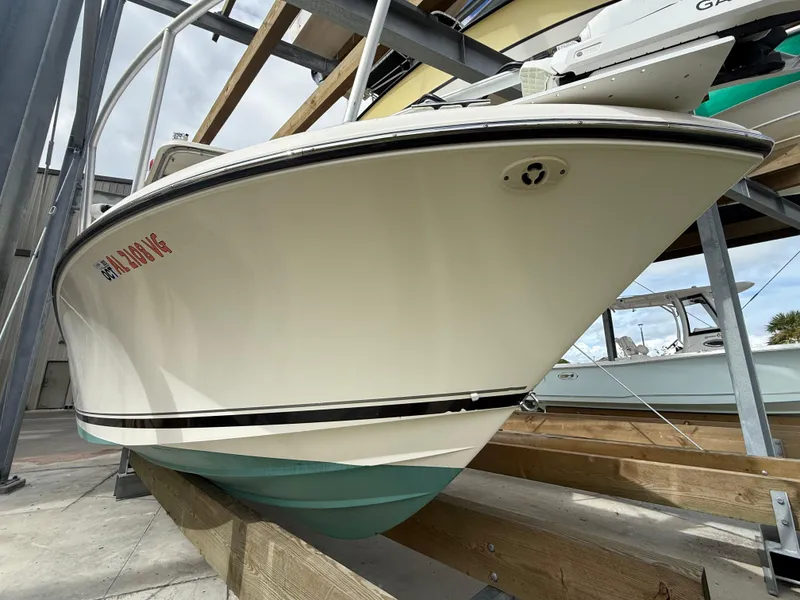 Slide: The Image of 2007 Pursuit 235 Denali LS boat on dry dock, showcasing sleek hull design. - 8