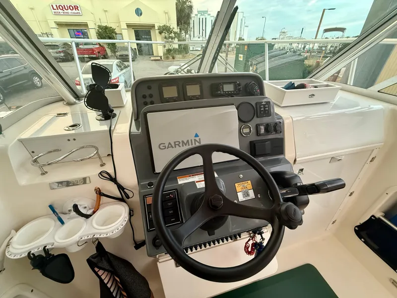 Slide: The Image of Interior view of 2007 Pursuit 235 Denali LS boat cockpit with Garmin navigation system. - 9