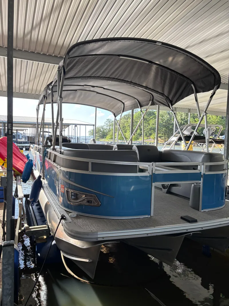 Slide: The Image of 2022 Tahoe Pontoon GT 2585 RF docked under a covered marina. - 10