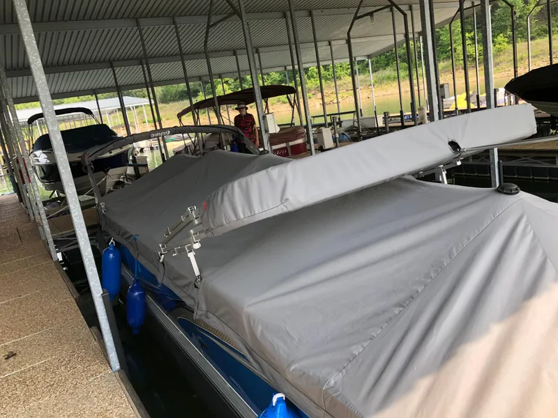 Slide: The Image of 2022 Tahoe Pontoon GT 2585 RF covered in a marina dock. - 12