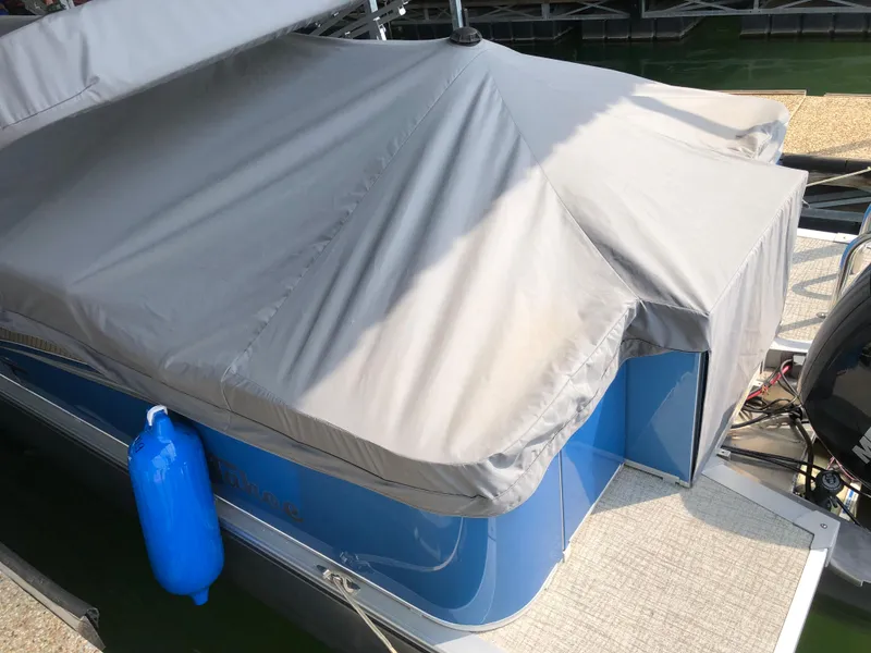 Slide: The Image of 2022 Tahoe Pontoon GT 2585 RF with gray cover docked on water. - 13