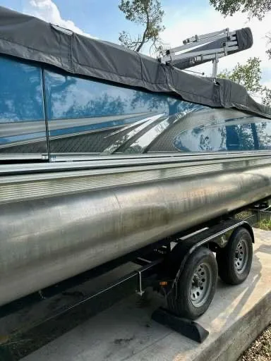 Slide: The Image of 2022 Tahoe Pontoon GT 2585 RF on trailer, blue exterior, covered, parked outdoors. - 15