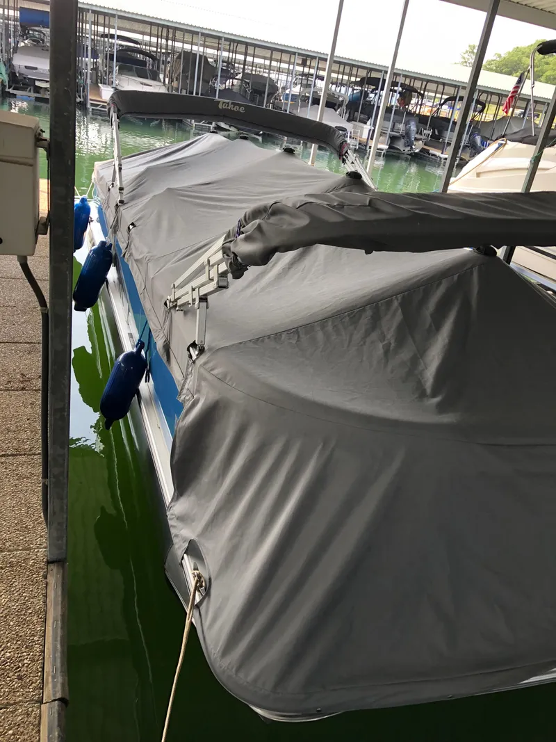 Slide: The Image of 2022 Tahoe Pontoon GT 2585 RF covered at marina dock. - 16