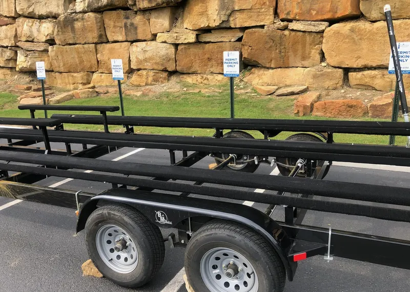 Slide: The Image of Trailer for 2022 Tahoe Pontoon GT 2585 RF parked near rocky wall. - 18