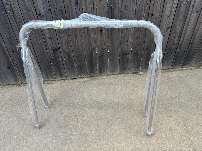 Slide: The Image of Packaged frame for 2022 Tahoe Pontoon GT 2585 RF against wooden fence. - 22