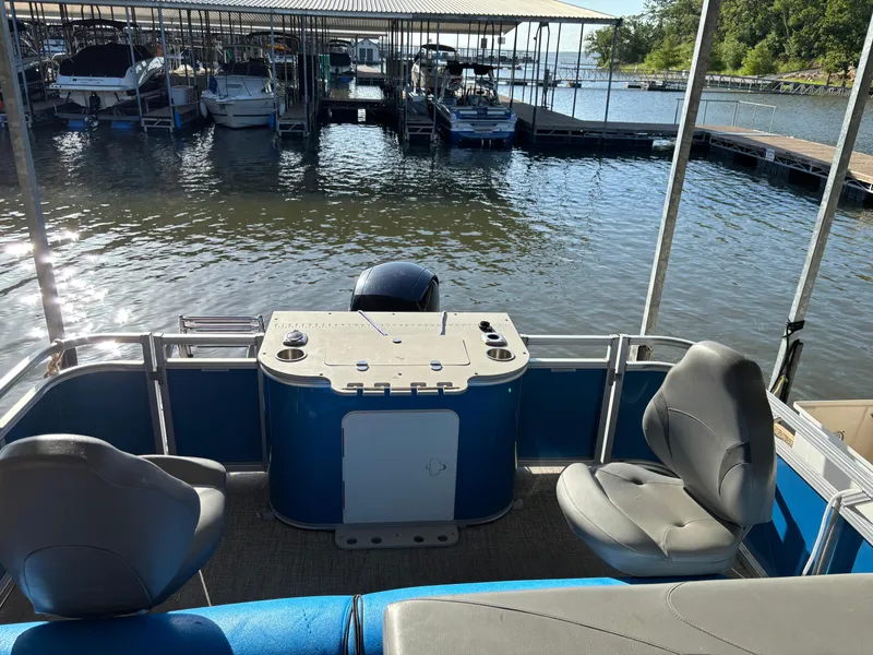 Slide: The Image of 2022 Tahoe Pontoon GT 2585 RF docked at marina with seating and console. - 6