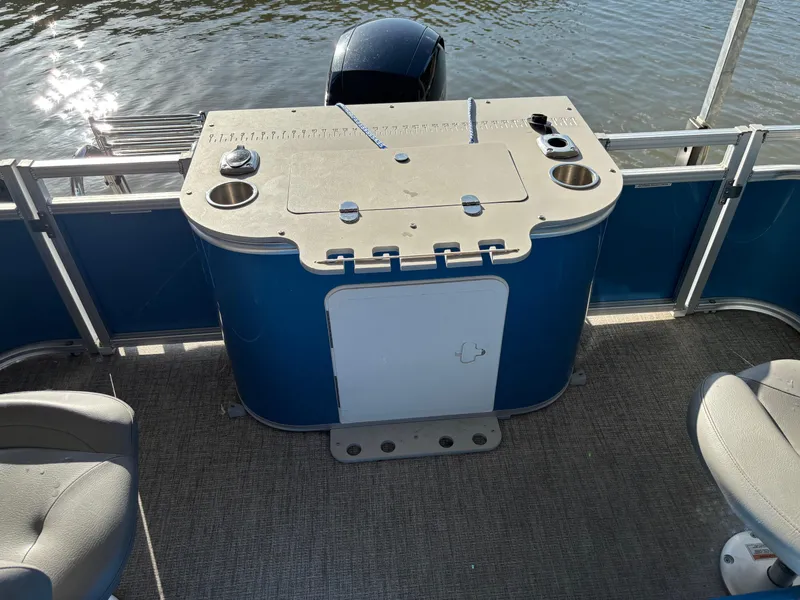 Slide: The Image of 2022 Tahoe Pontoon GT 2585 RF boat interior with seating and storage, near water. - 9