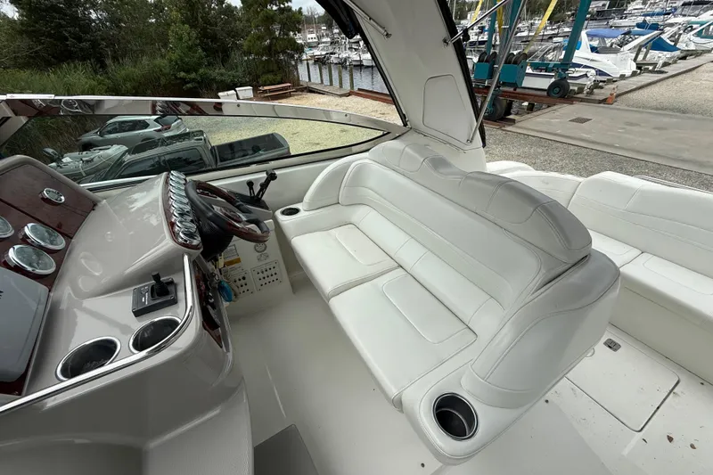 Slide: The Image of 2003 Formula 37 PC boat interior with white seating and control panel. - 10