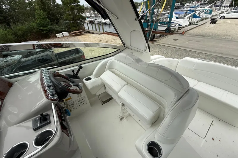 Slide: The Image of 2003 Formula 37 PC yacht interior with white seating and control panel, docked at marina. - 11