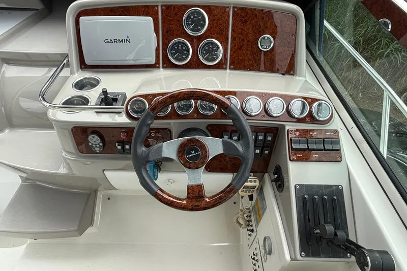 Slide: The Image of 2003 Formula 37 PC boat dashboard with Garmin navigation system and wood accents. - 12